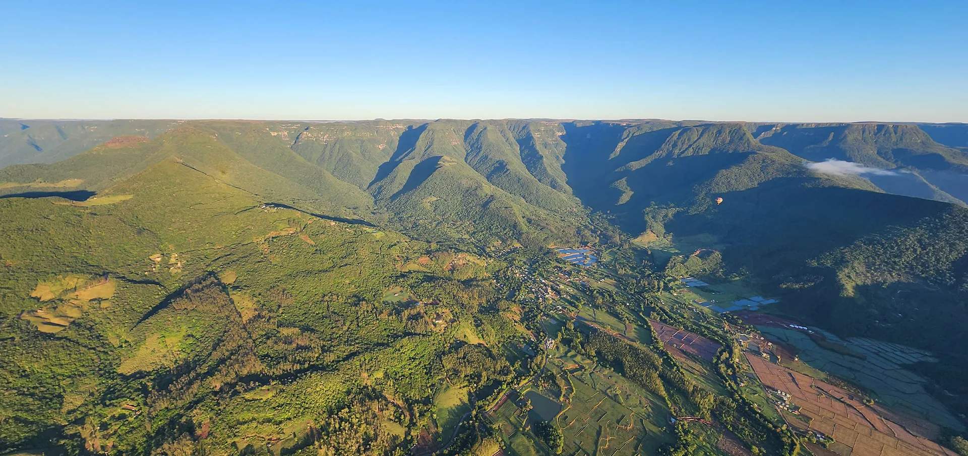 Vista aérea dos cânions e vales verdes de Praia Grande vistos do balão
